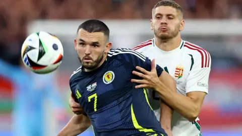 Reuters Scotland's John McGinn in action against Hungary's Marton Dardai during the 2024 European Champinships in Germany  