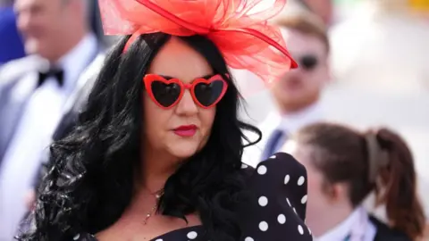 PA Media A racegoer on day two of the Randox Grand National Festival 2026 at Aintree Racecourse.