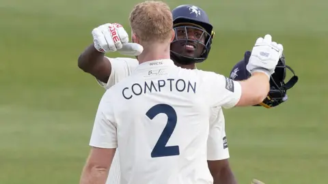 Ben Compton hugs Tawanda Muyeye