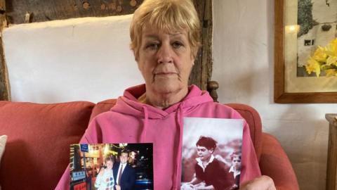 Maggie Stephens holding photos of her late son