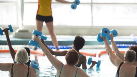 People taking part in a water aerobics class in a swimming pool