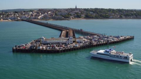 A Wightlink camataran ferry approaches the ferry terminal at the end of Ryde Pier