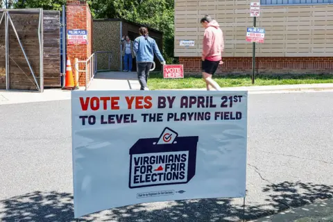 A "Vote Yes" sign as voters arrive to cast their ballots at a polling location inside Abingdon Elementary School during a special election in Arlington, Virginia, US, on Tuesday, April 21, 2026.