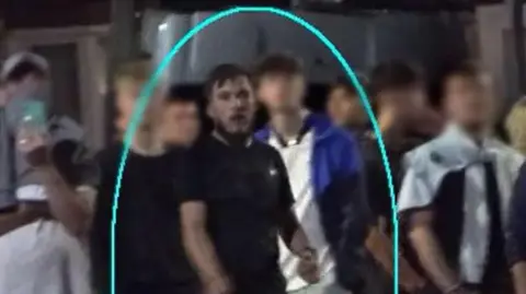 Cleveland Police A group of men stand in a street, one is circled in blue.