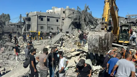 BBC Rescue workers and civilians hunt for survivors aft an Israeli aerial onslaught destroyed respective buildings adjacent Rafik Hariri University Hospital successful confederate Beirut, Lebanon (22 October 2024)