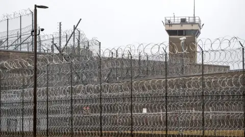 An outside view of the exterior of the Potosi Correctional Centre in Mineral Point, Missouri, showing a barbed fence and watchtower, in 2023