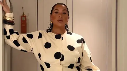 Grace Victory Grace wears a white polka dot dress