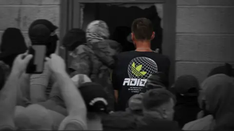 Reuters A person wearing a black top with a green logo