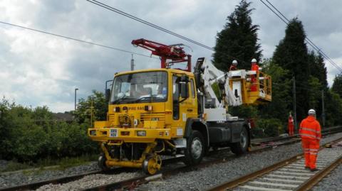 Repairs being carried out to the overhead lines