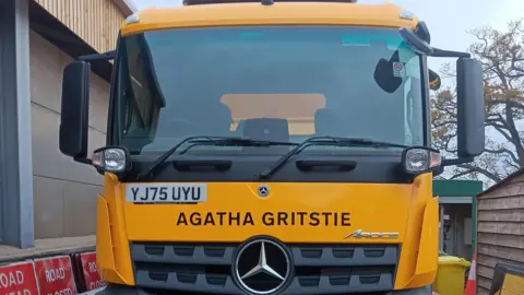 Oxfordshire County Council A close-up of a yellow gritter named Agatha Gritsie, after crime author Agatha Christie.
