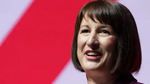 Rachel Reeves smiles while delivering a speech at an event