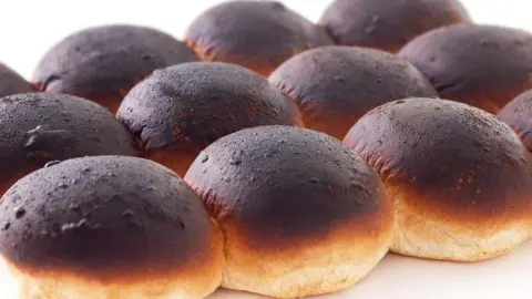Morton's rolls Twelve morning rolls with burnt blackened tops still attached together