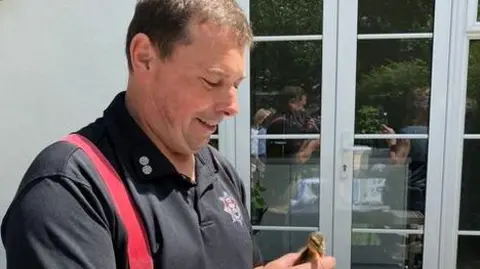 RSPCA one of the rescuers holding a duckling