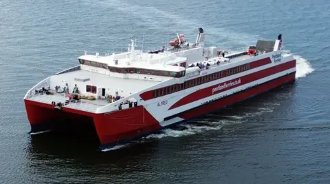 A red and white catamaran ferry with Pentland Ferries written on the side