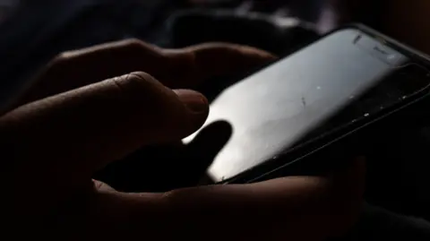 Generic view of hands on a mobile phone