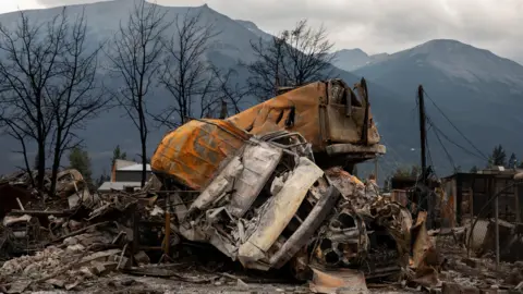 Reuters Vehicles wrecked by wildfires in Jasper