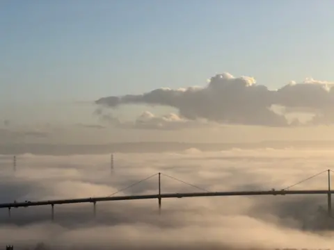 Tom Howe The Erskine bridge surrounded by thick fog during the day.