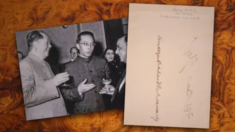 Dawsons On picture on the right of Mao Zedong talking with another chines official and the then PM of Pakistan. On the right hand side is a sheet of paper with Zedong's signature.