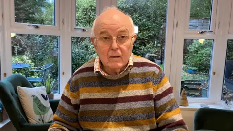 Greg Scott in a stripey jumper 