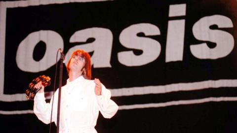 Liam Gallagher in 1996, performing with Oasis at Knebworth