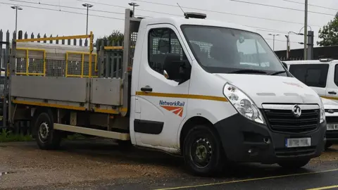 Rail Accident Investigation Branch A close up of the white van involved in the near miss in Bedfordshire. It is parked up in front of a fence