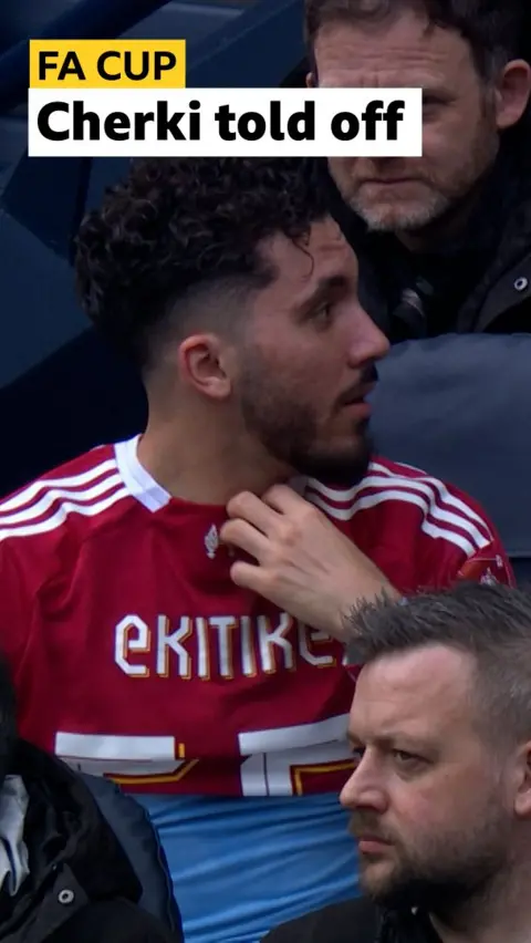 Rayan Cherki being told off by coaching staff for wearing Ektike's Liverpool shirt at Man City's FA Cup match against Liverpool
