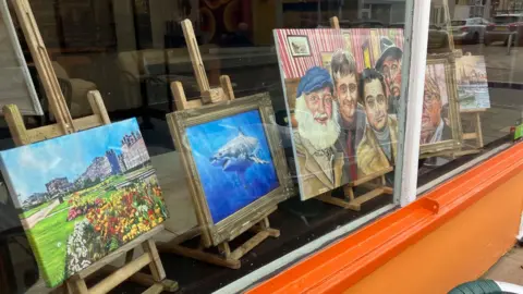 Guy Campbell/BBC Artworks in the window of Desmonds, Lowestoft