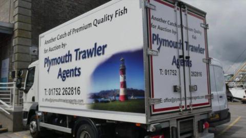 A photo of a lorry with the Plymouth Trawler Agents branding on it