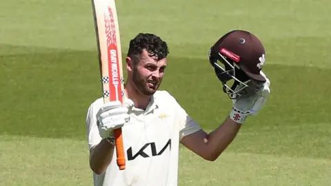 Dom Sibley raises his bat after bringing up his triple century 