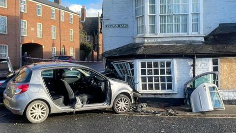 A collision involving two cars and a pub building
