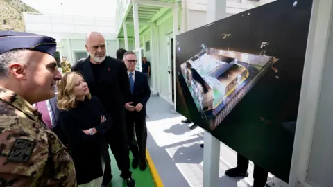 Giorgia Meloni and Edi Rama look at a rendering of a migrant centre on a screen