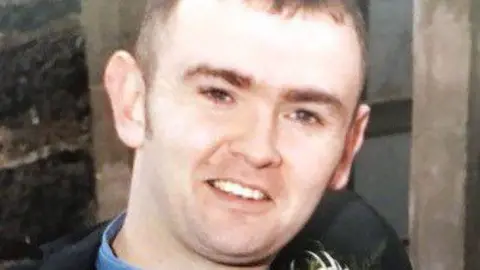 Family Handout Headshot of a man smiling looking at the camera