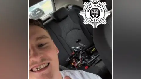 West Mercia Police A man sits in the front seat of a vehicle with a drone pictured in the back of the car.