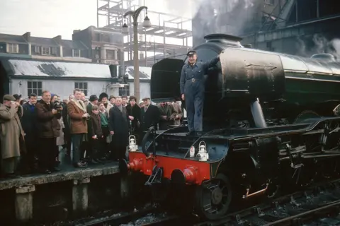 Getty Images Flying Scotsman" at King's Cross station in 1963, before its last journey to Doncaster, where it was made. Alan Pegler, who bought Flying Scotsman for £3,000, is pictured at the front of the locomotive.