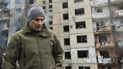Getty Images Kyiv Mayor Vitali Klitschko inspects a multi-storey residential building damaged by a missile strike in central Kyiv, on January 2, 2024, amid Russia's invasion of Ukraine