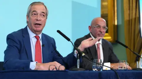 Nigel Farage speaks at a press conference alongside Nadhim Zahawi.