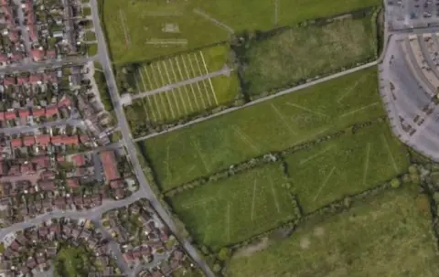 The green space where the new houses are being planned, with other houses pictured nearby