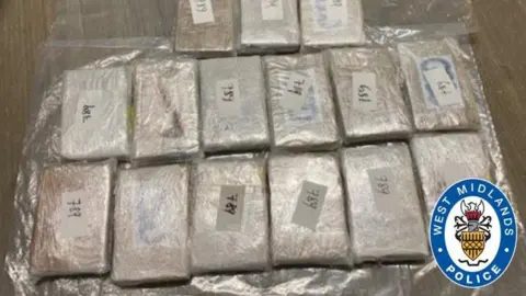 West Midlands Police Several rectangular clingfilm-wrapped items. It is hard to tell what is inside them.