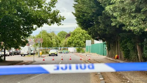 Leicester Media Online A police cordon with cars parked inside the taped off area