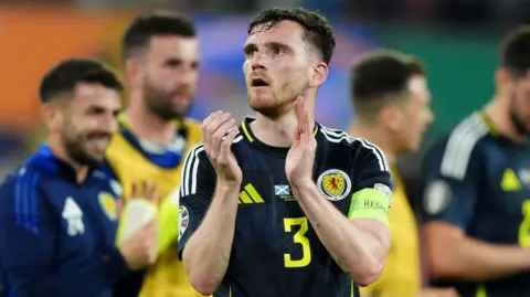 PA Andy Robertson applauds Scotland fans