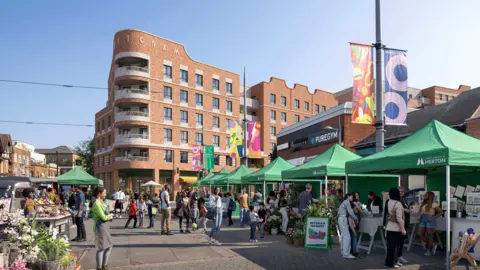 A computer-generated image shows a large brick building with a curved front standing above a market with green canopies and various stallholders and shoppers. 
