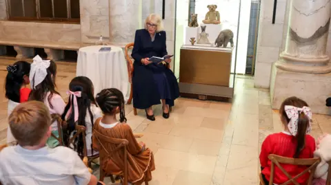 PA Media Queen Camilla reads Winnie-the-Pooh to children during a visit to the New York Public Library to celebrate literature,
