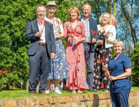 The Myton Hospices People with red metal butterflies