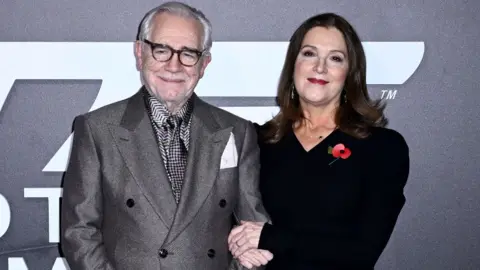 Getty Images Brian Cox and Barbara Broccoli arrive at the "007: Road To A Million" Premiere at Battersea Power station on November 02, 2023 in London, England