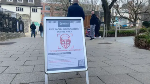 Aimee Dexter/BBC A sign warning of live facial recognition recording taking place in Norwich city centre.