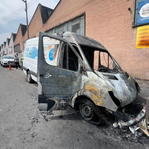 Contributed A van which has been badly damaged by fire parked in front of a brick wall
