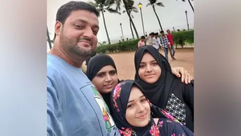 Dokadia family in happier times - Abdullah and wife Nasreen with their two daughters Ayesha and Zainab