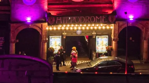 Oliv3r Drone Photography Aerial view of the entrance to Great Yarmouth Hippodrome shows a group of people in conversation, including at least one firefighter.