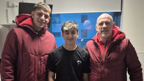 Lloyd Griffiths Ethan in hospital flanked by Jenkins and a tandy 