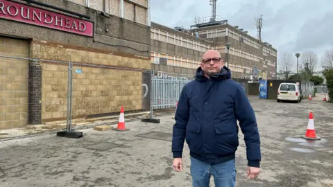 Chaz Fenner Chaz Fenner in front of the derelict building 